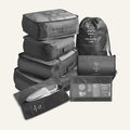 The seven grey packing pieces: cubes, drawstring bag, flat pouch and shoe bag