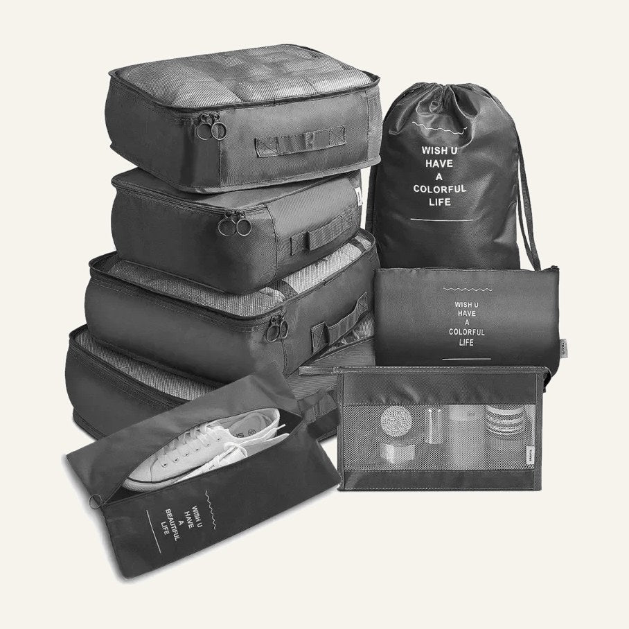 The seven grey packing pieces: cubes, drawstring bag, flat pouch and shoe bag