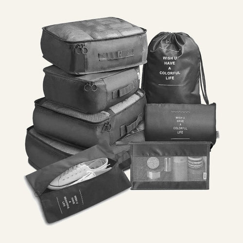 The seven grey packing pieces: cubes, drawstring bag, flat pouch and shoe bag