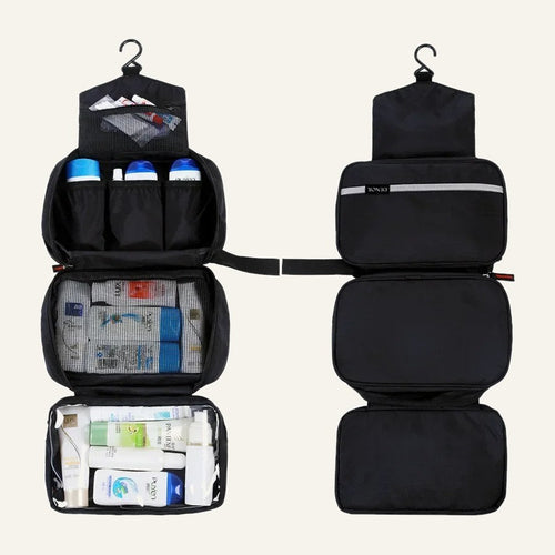 The black toiletry bag hanging open with pockets filled, next to it folded closed
